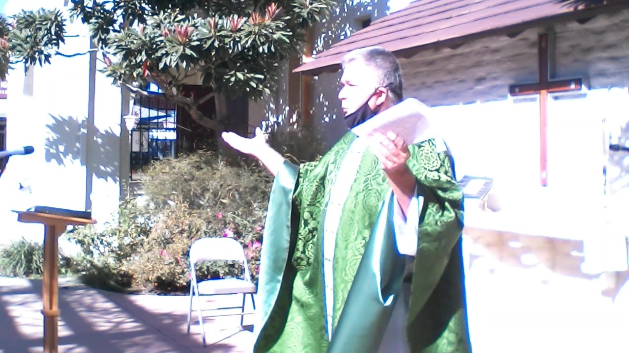 Father Carlos preaching at our courtyard Mass